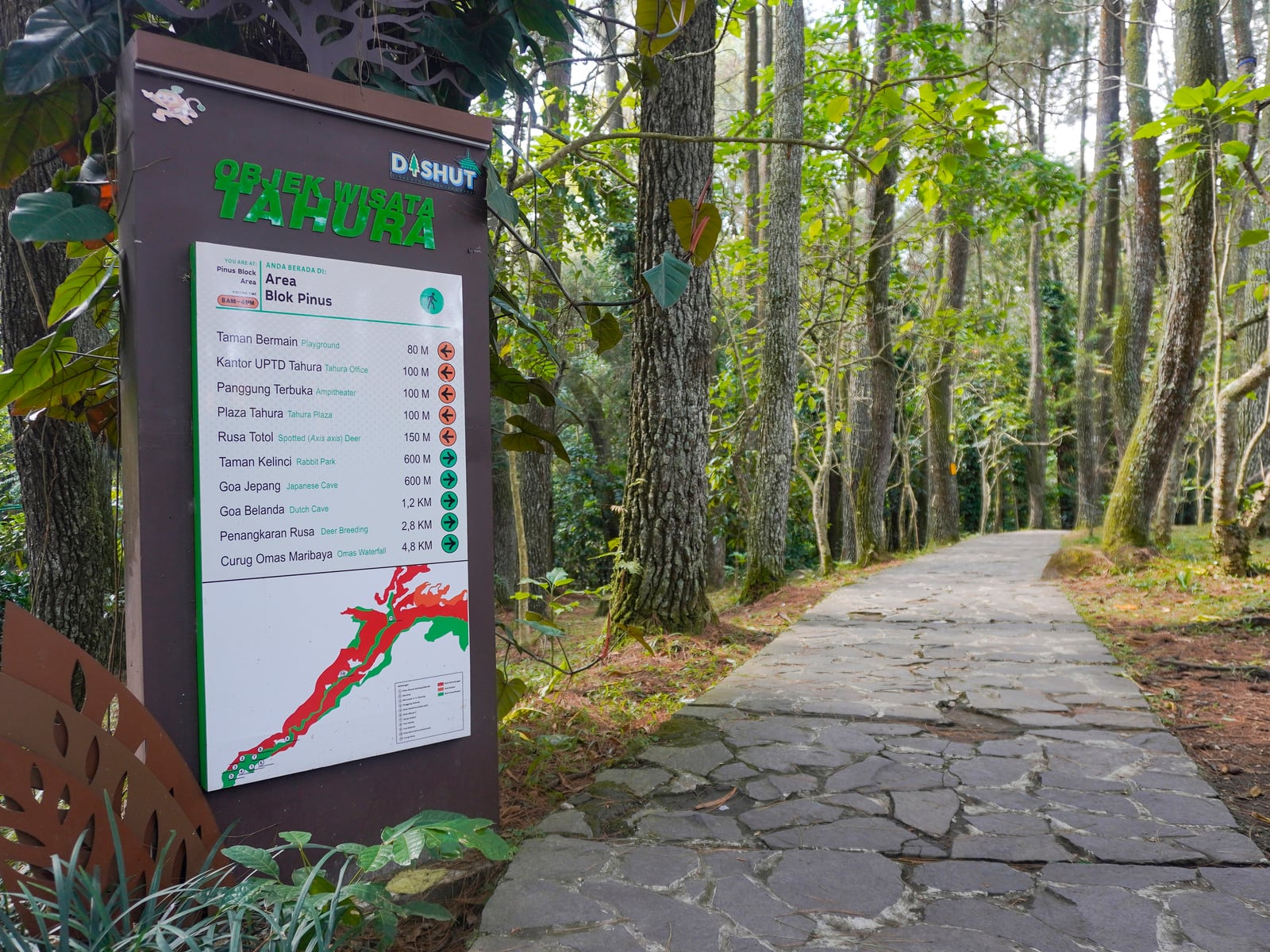 Trail and visitor sign in Tahura Djuanda forest park near Bandung