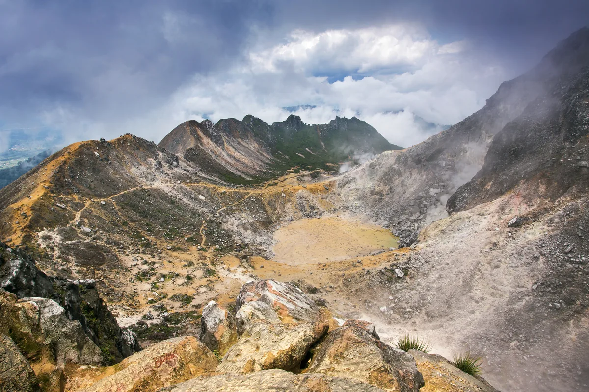 Sulfur-stained rocks and crater floor on Mount Sibayak