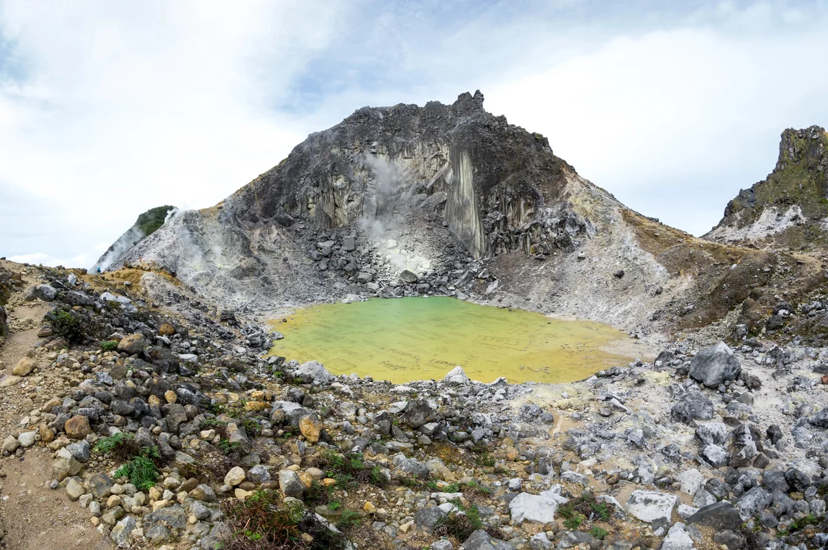 Sulfur-colored crater pool on Mount Sibayak